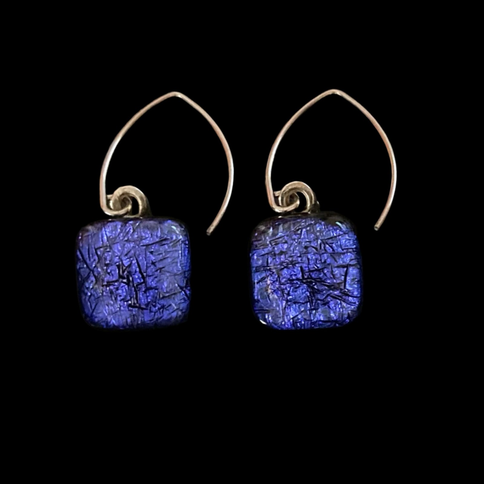 A pair of pierced earrings with blue dangles against a grey background, by 3D Glass Designs. 