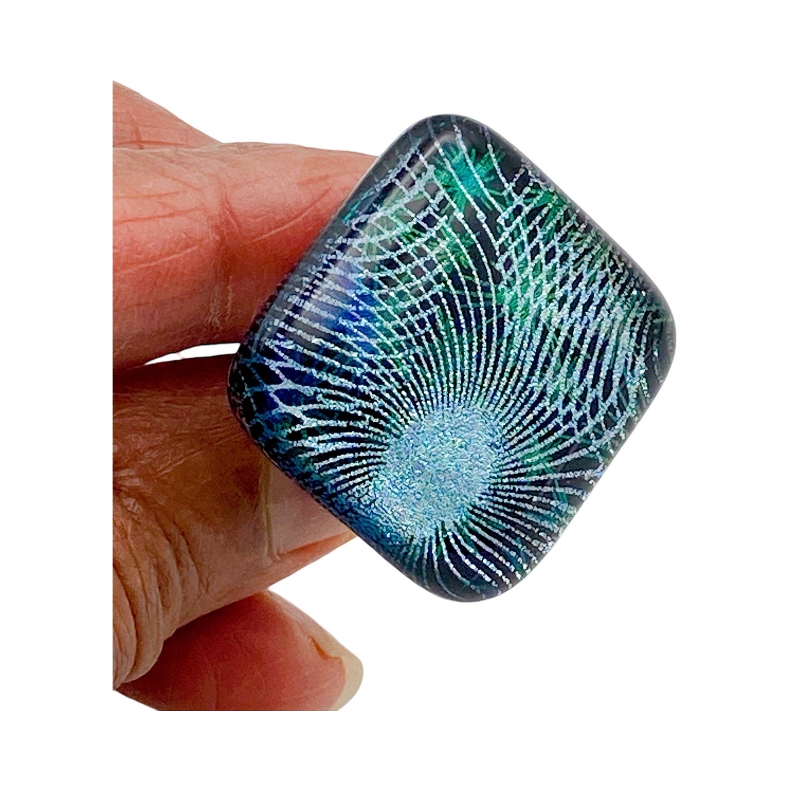 Hand holding handmade fused glass furniture knob, by 3D Glass Designs.