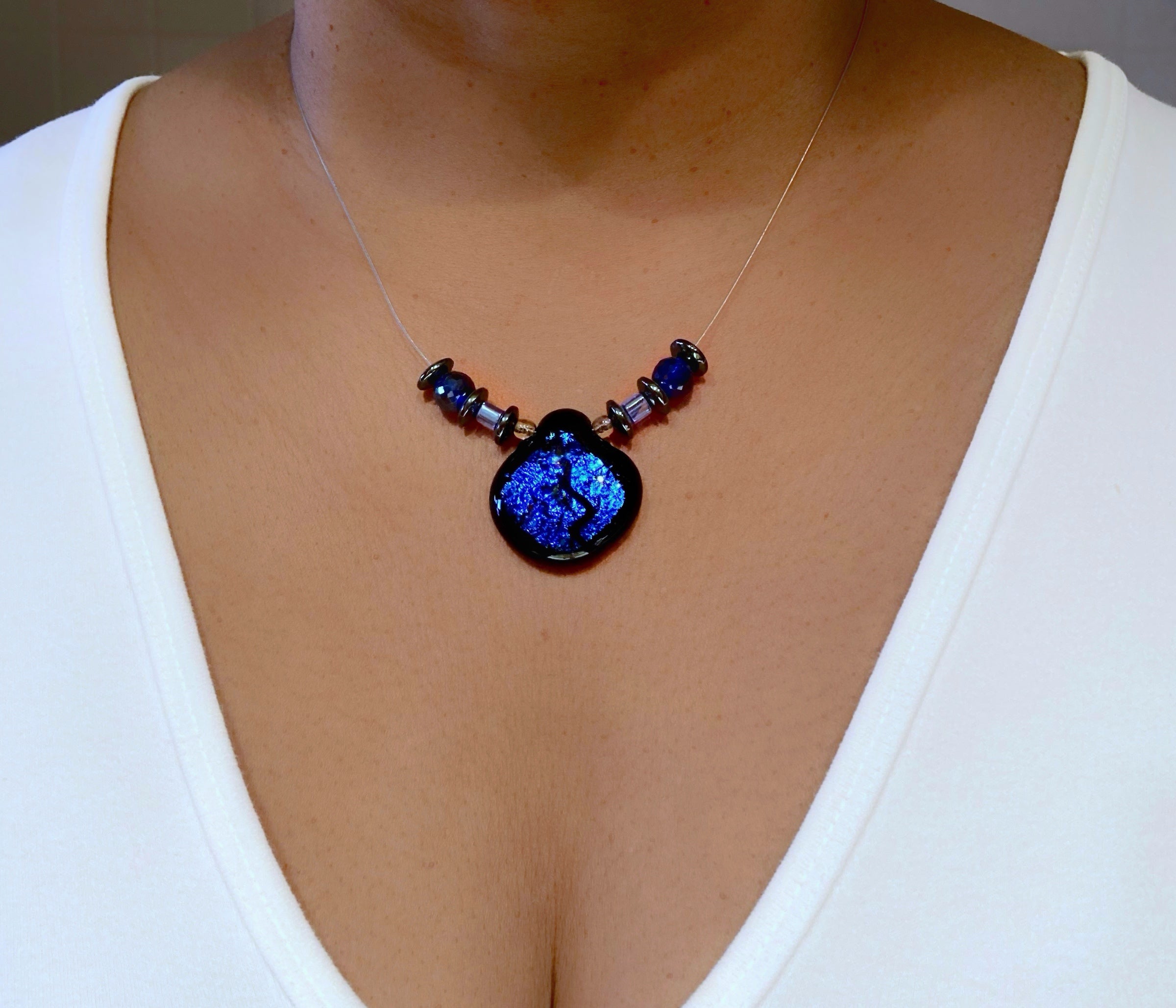 Model wearing handmade illusion style beaded necklace and a white tee-shirt, by 3D Glass Designs.
