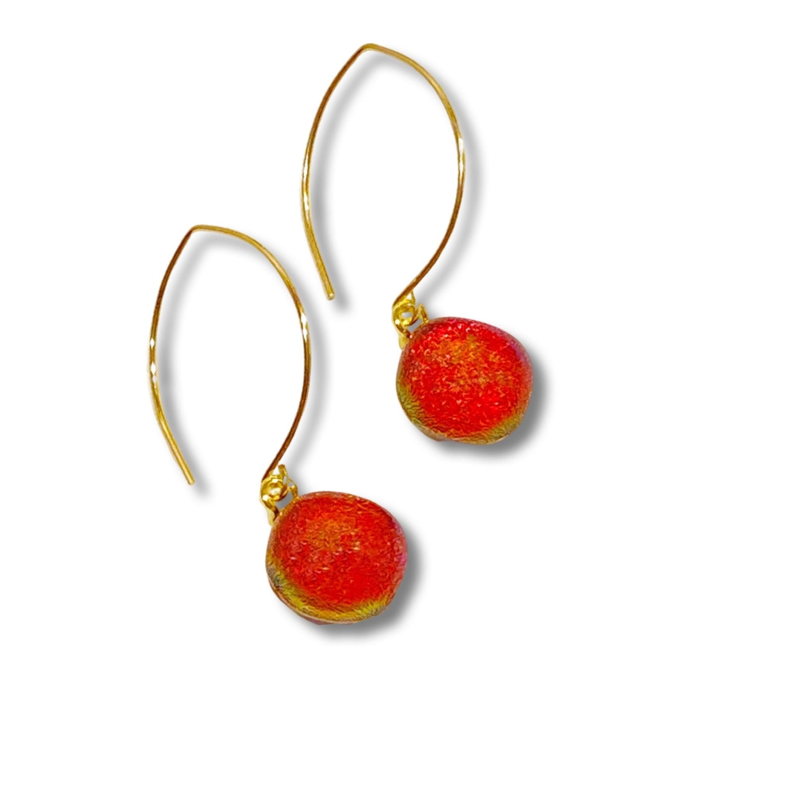 A pair of pierced earrings with red glass drops on gold ear wires against a white background, by 3D Glass Designs.