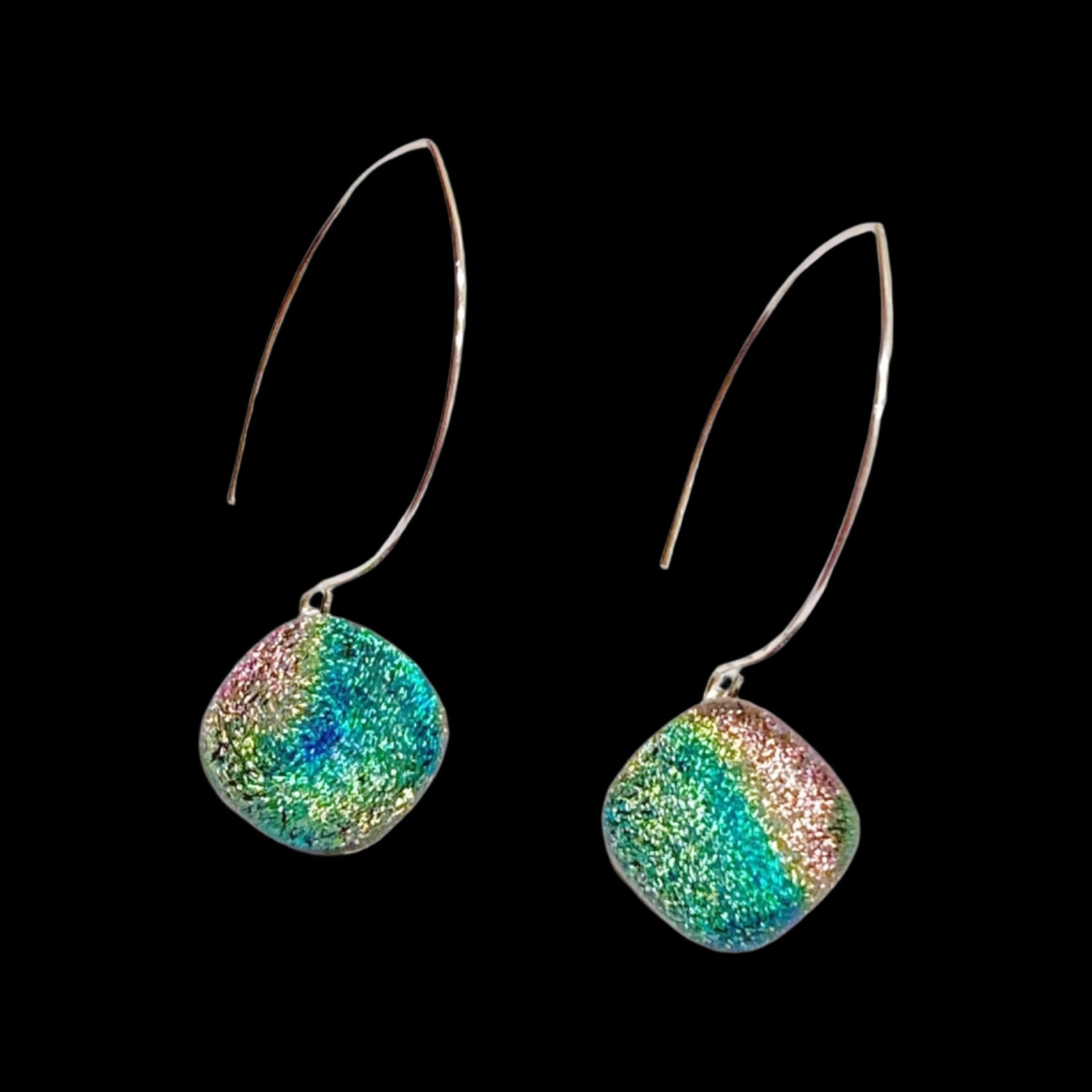 A pair of long earrings with fused glass dangles, by 3D Glass Designs.