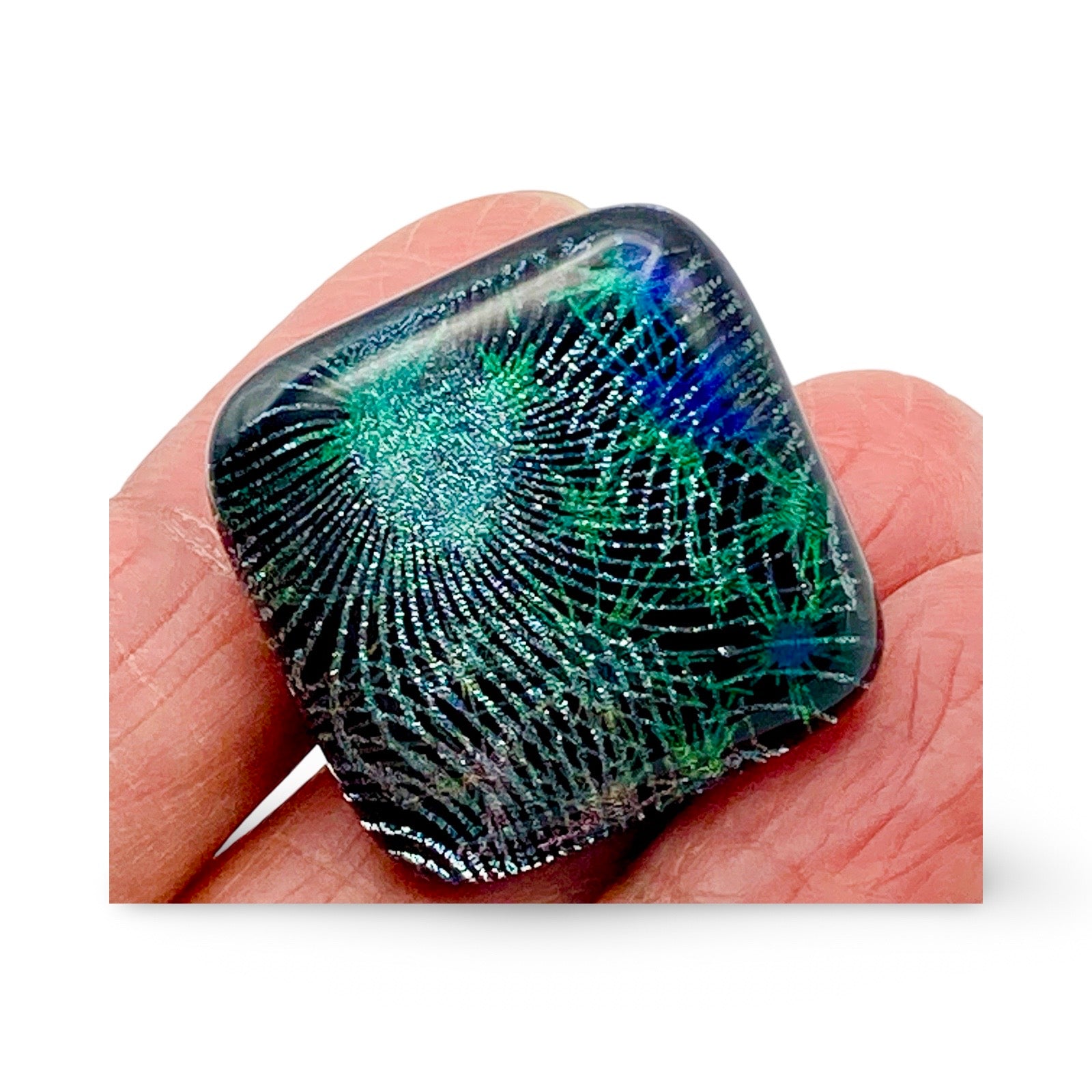 Hand holding handmade fused glass furniture knob, by 3D Glass Designs.
