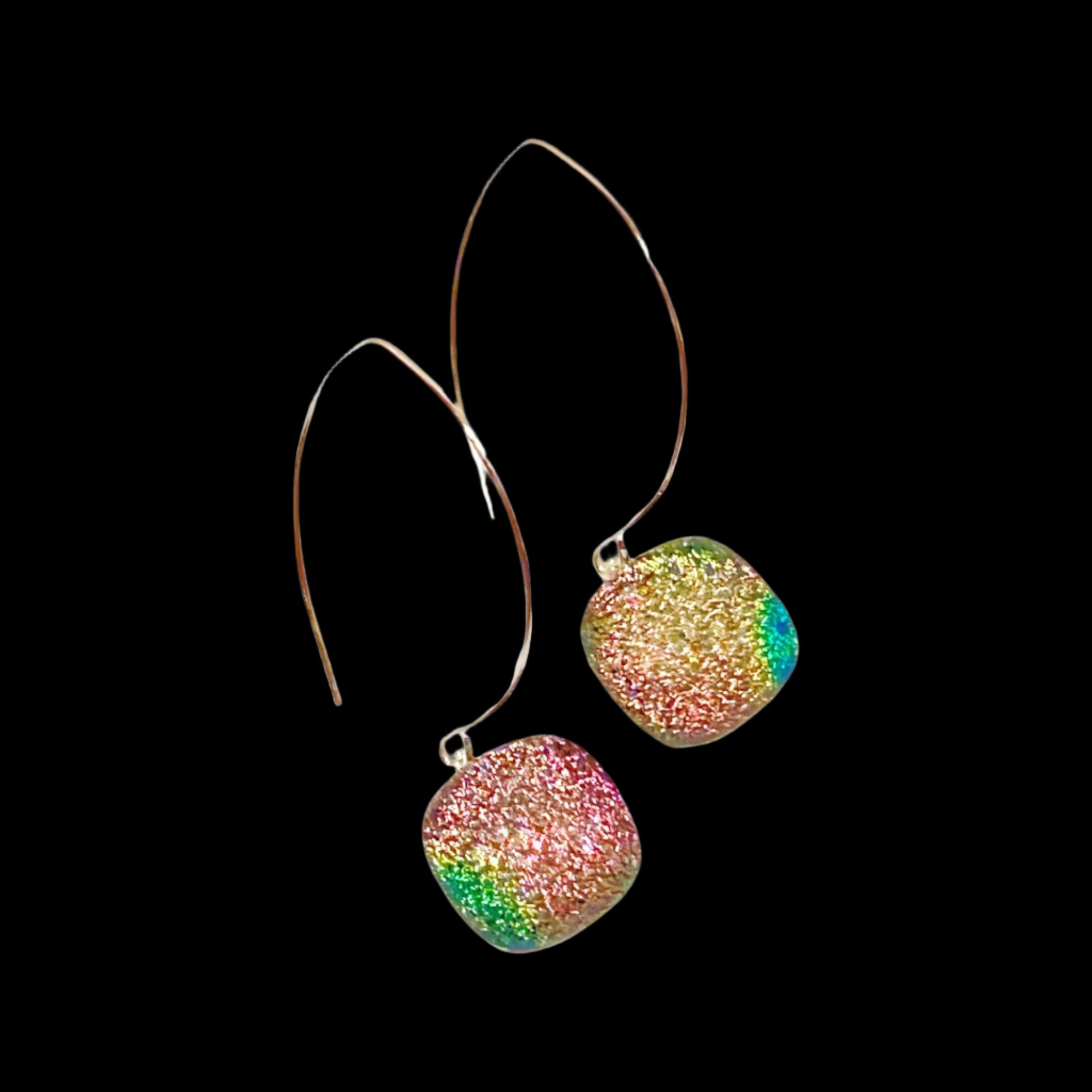 Long drop earrings with silver-plated ear wires and square pink-green dichroic glass dangles.  By 3D Glass Designs.