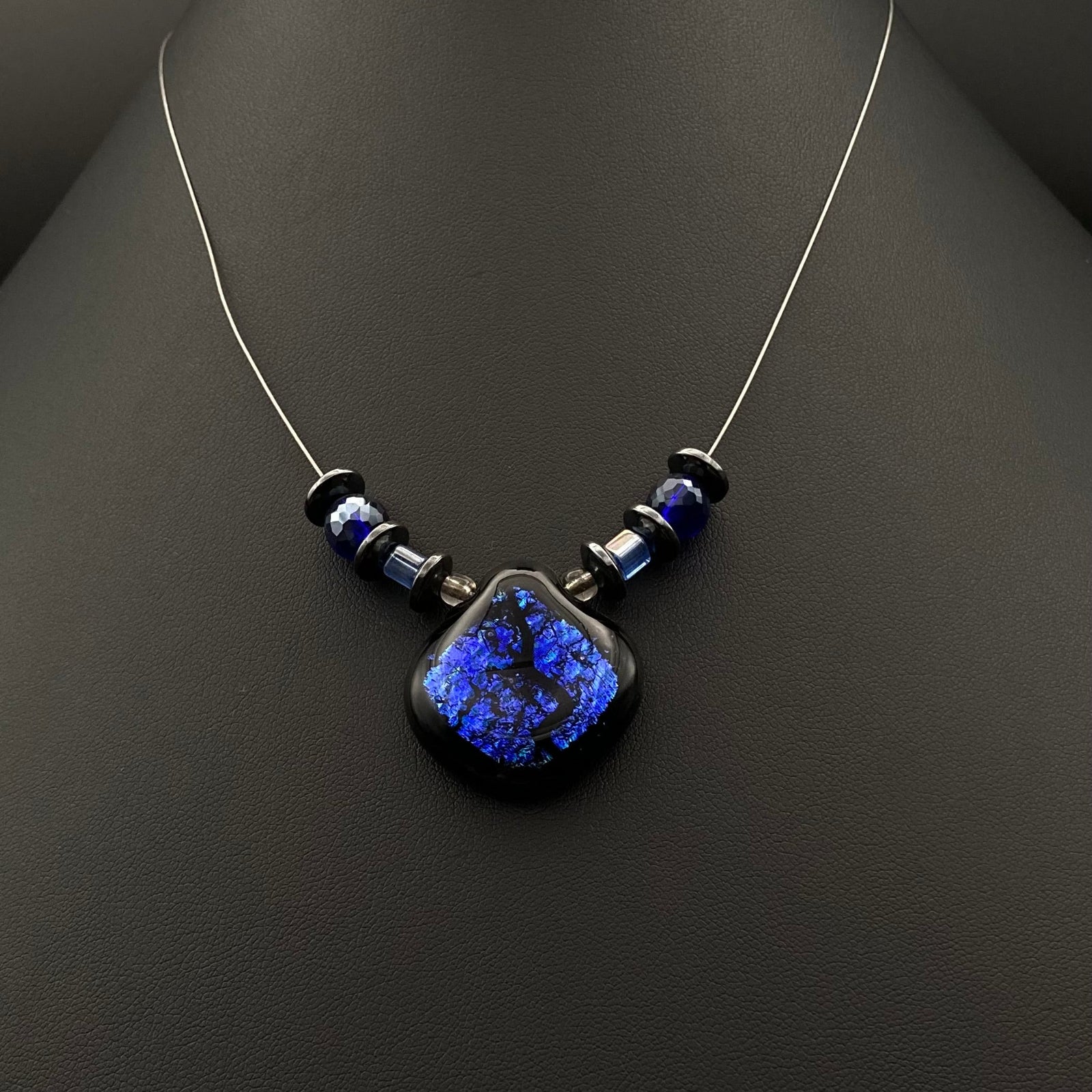 Purple-blue pendant necklace on a silver cord, by 3D Glass Designs.