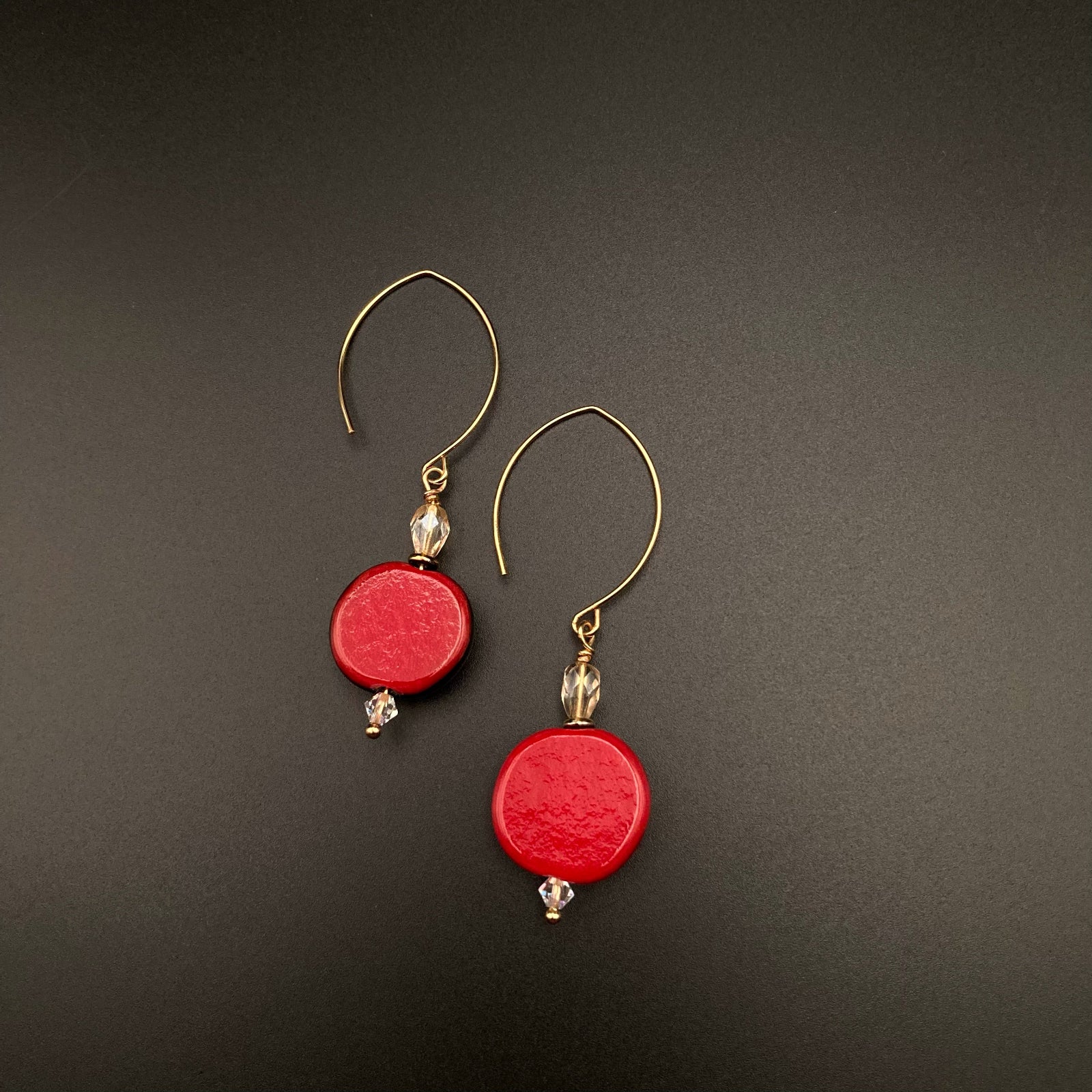 A pair of red glass earrings with gold ear wires, by 3D Glass Designs.