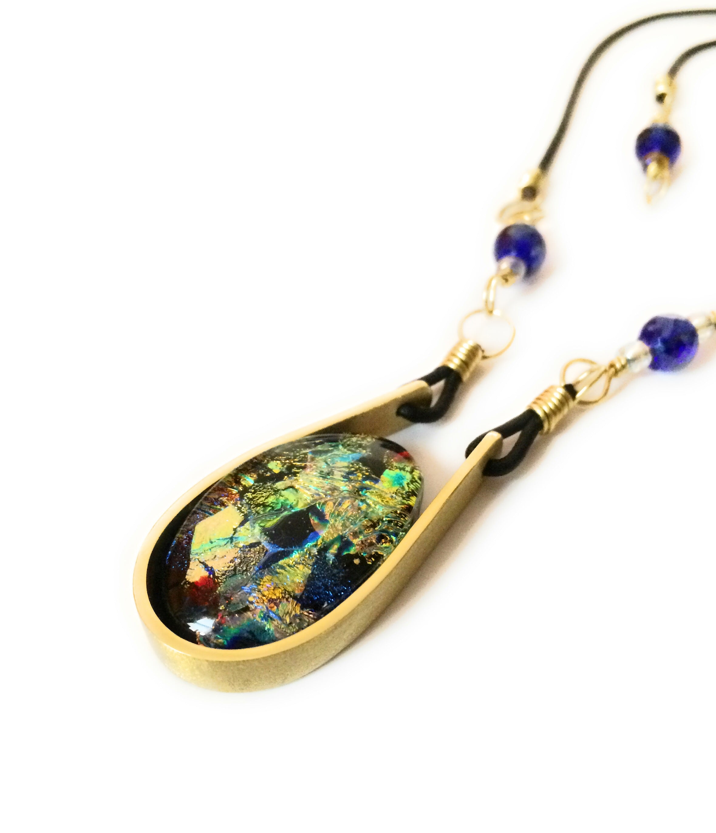 Modern fused dichroic glass and brass pendant with a beaded leather cord, by 3D Glass Designs.