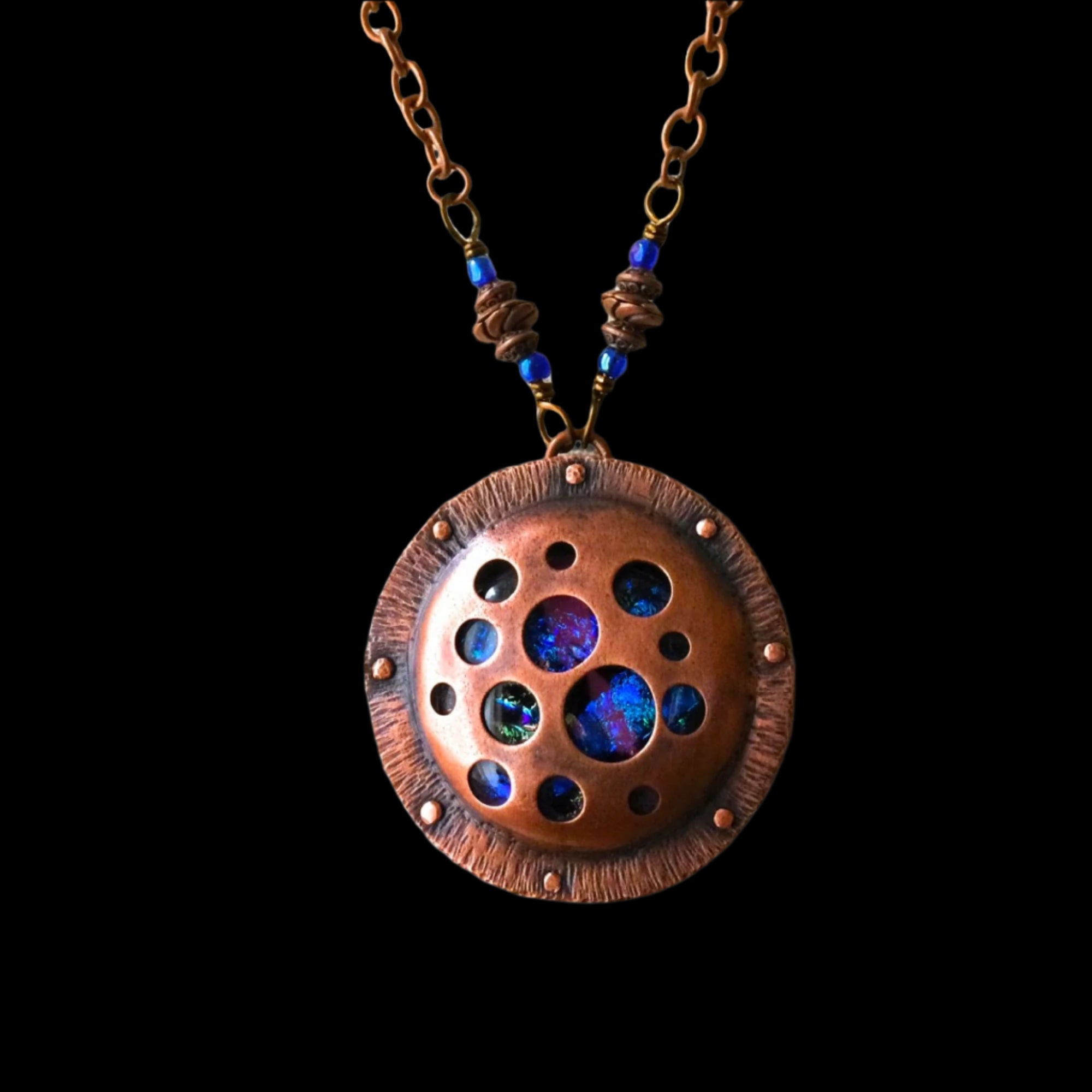 Round copper and dichroic glass pendant with a copper chain, by 3D Glass Designs.