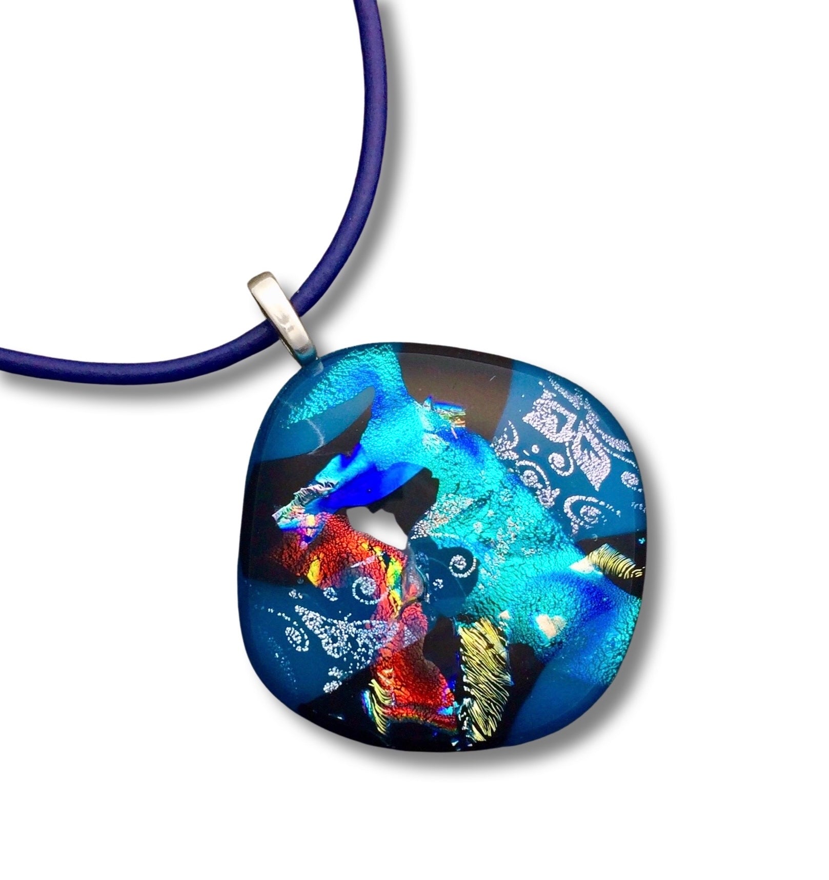 Fused glass pendant in teal, red, silver, blue and gold on a blue 18-inch leather cord, by 3D Glass Designs.
