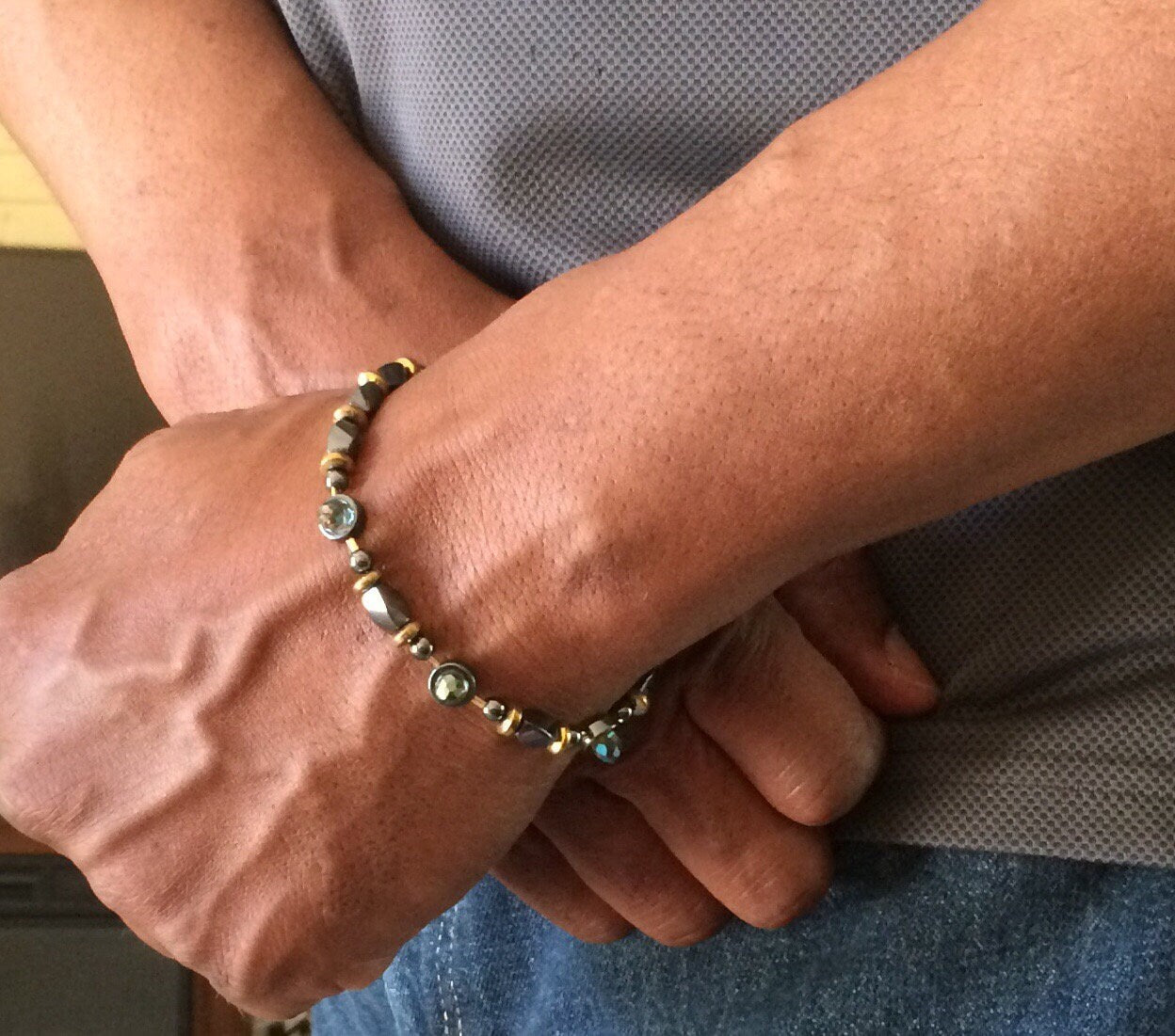 Model wearing hematite and crystal beaded bracelet, by 3D Glass Designs.