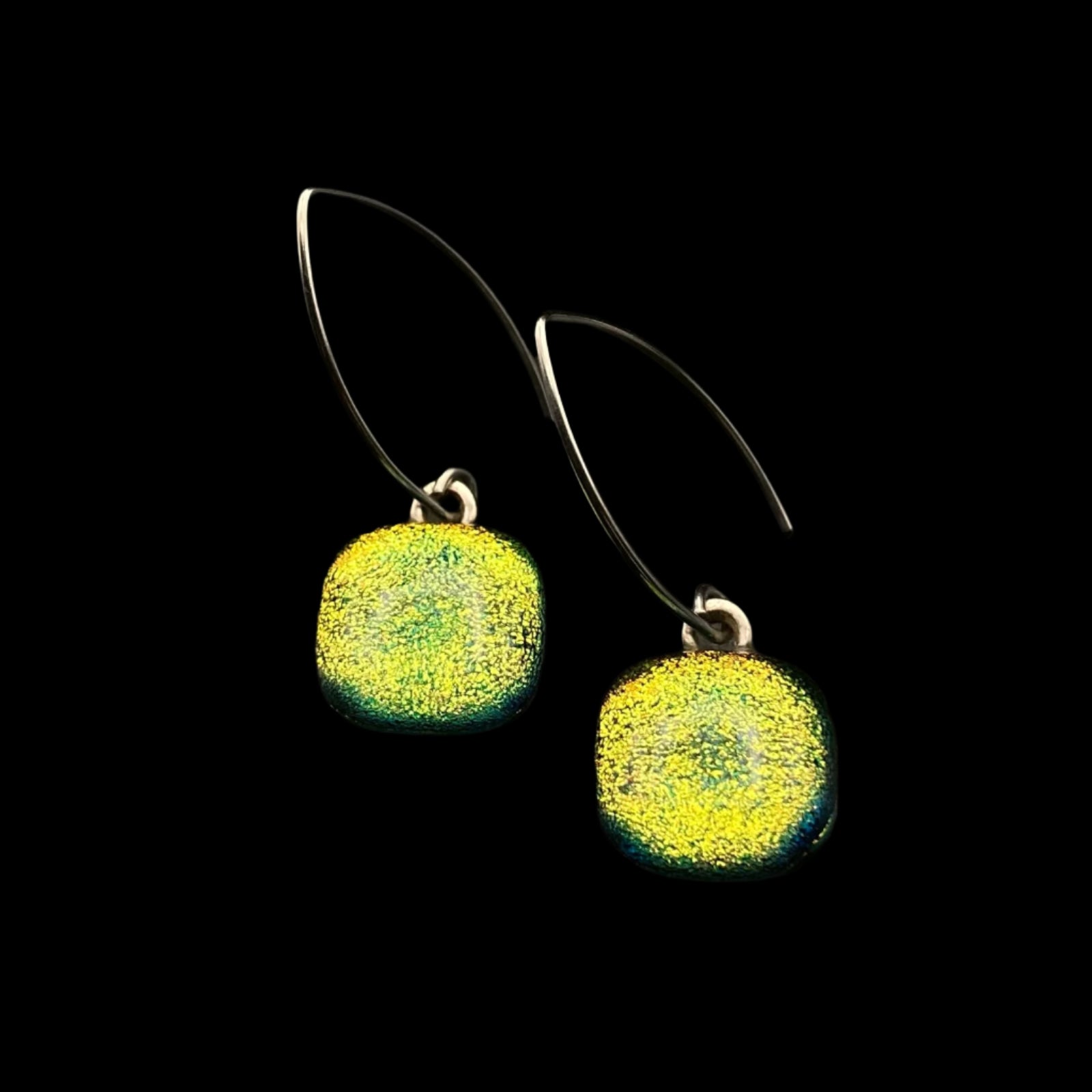 Yellow glass earrings with silver ear wires on a black background, by 3D Glass Designs.