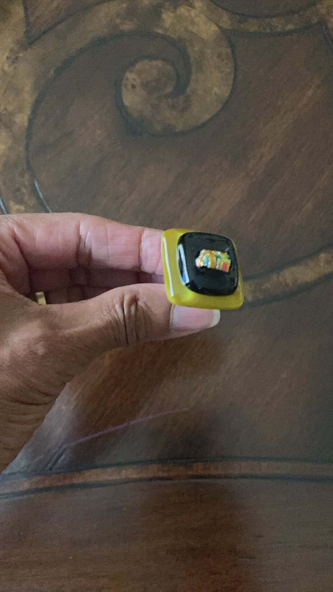Hand showing different angles of fused glass cabinet knob, by 3D Glass Designs.