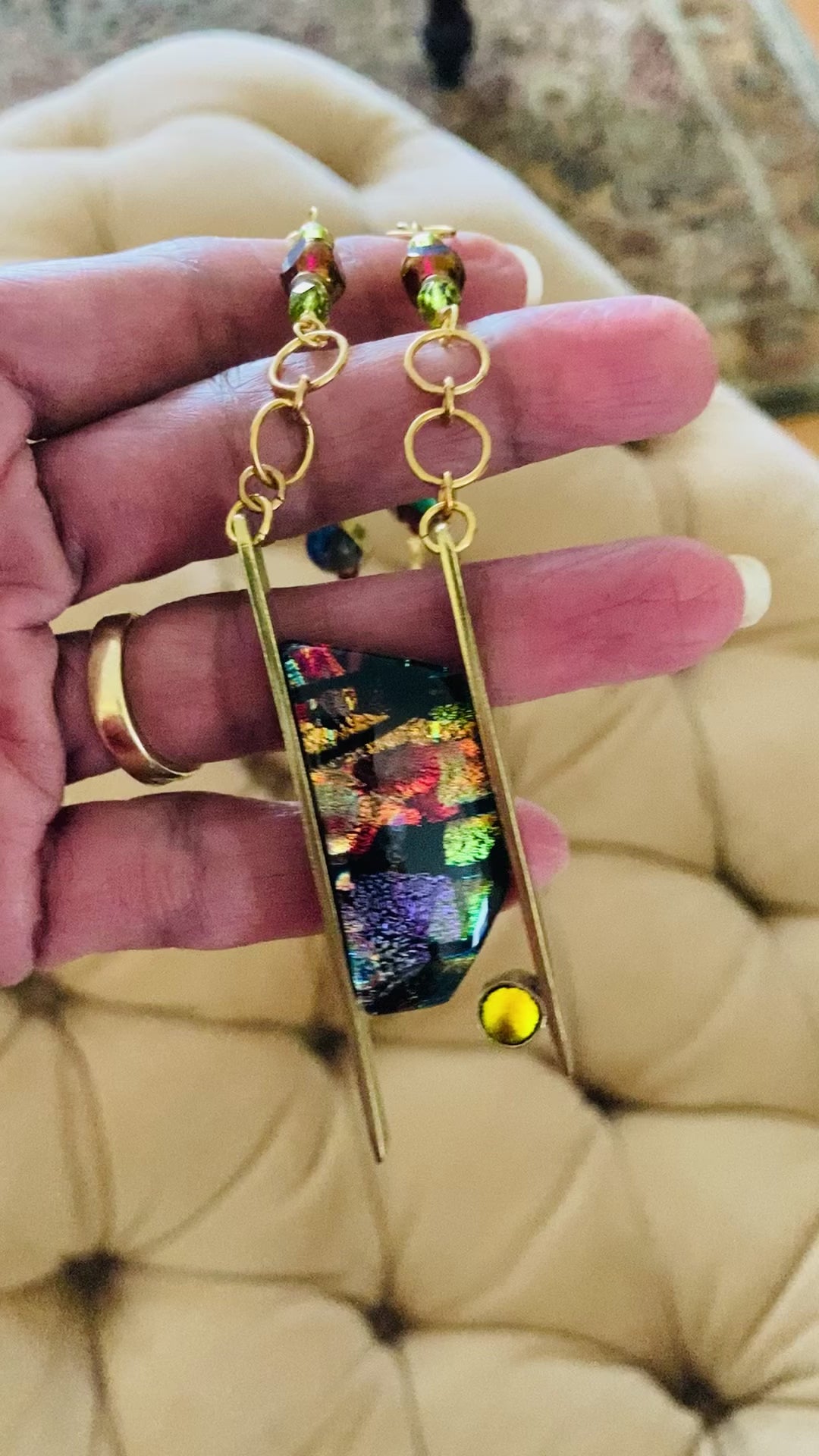 Video of hand holding contemporary dichroic glass pendant necklace, by 3D Glass Designs.